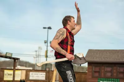 Lumberjack raising hand to the crowd