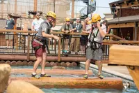 two men facing off on log roll at lumberjack feud