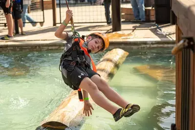 child taking part in the Loggersports portion of the Adventure Park